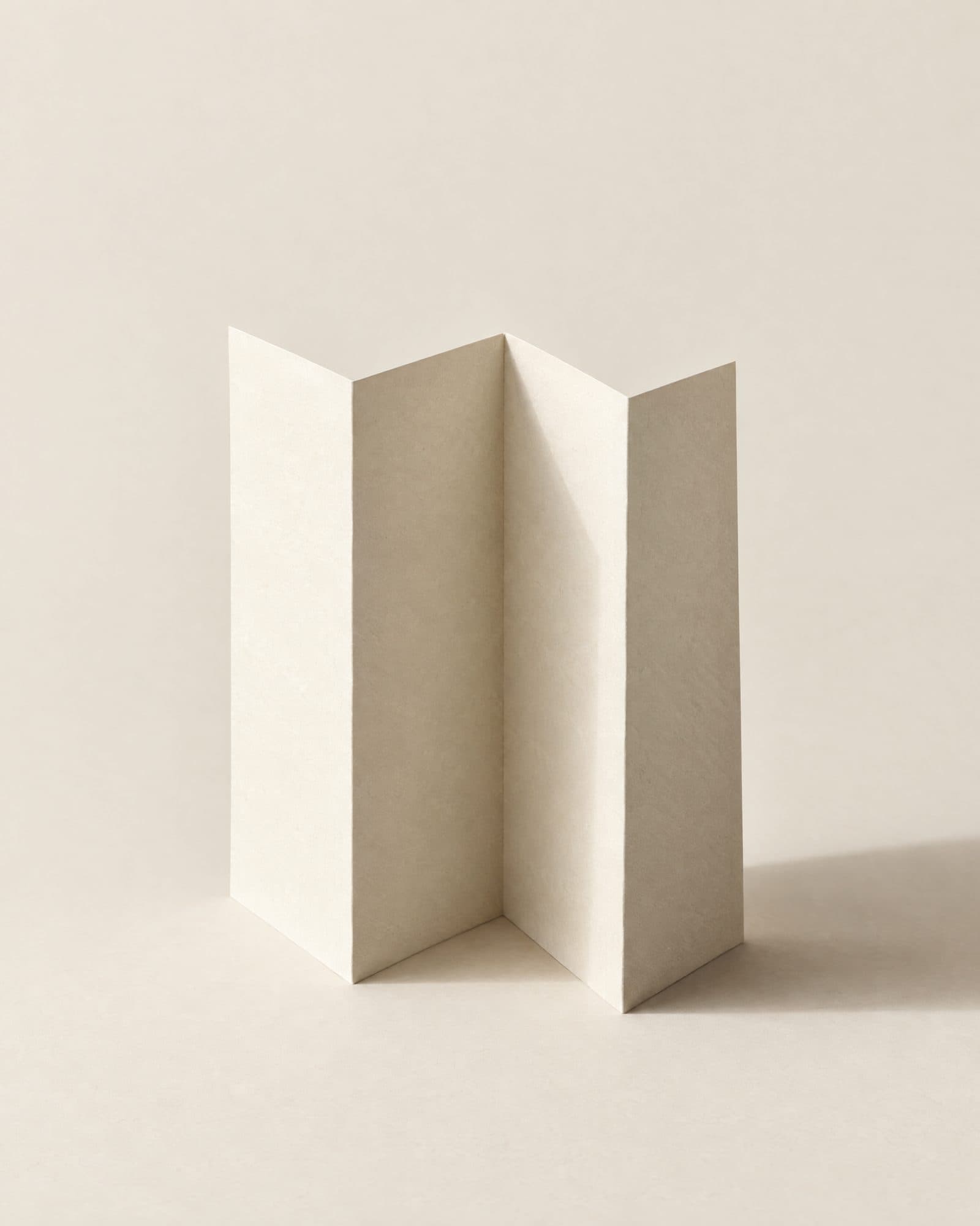 A sheet of off-white paper folded into a precise standing form