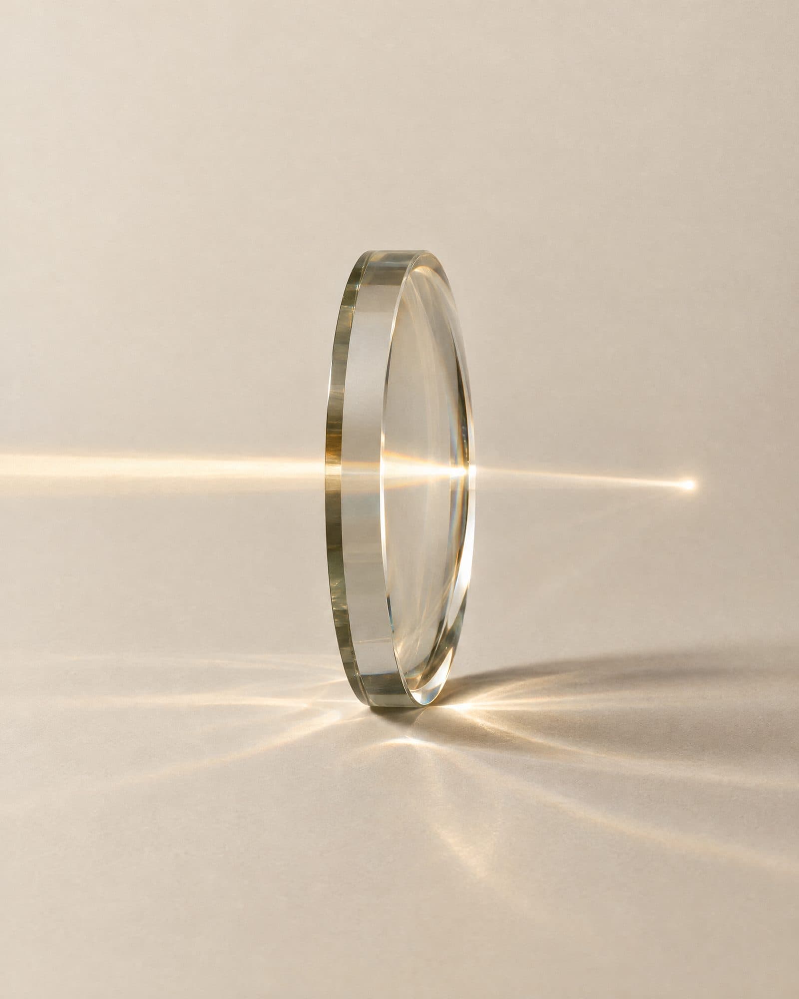 A disc of optical glass focusing a beam of light to one point